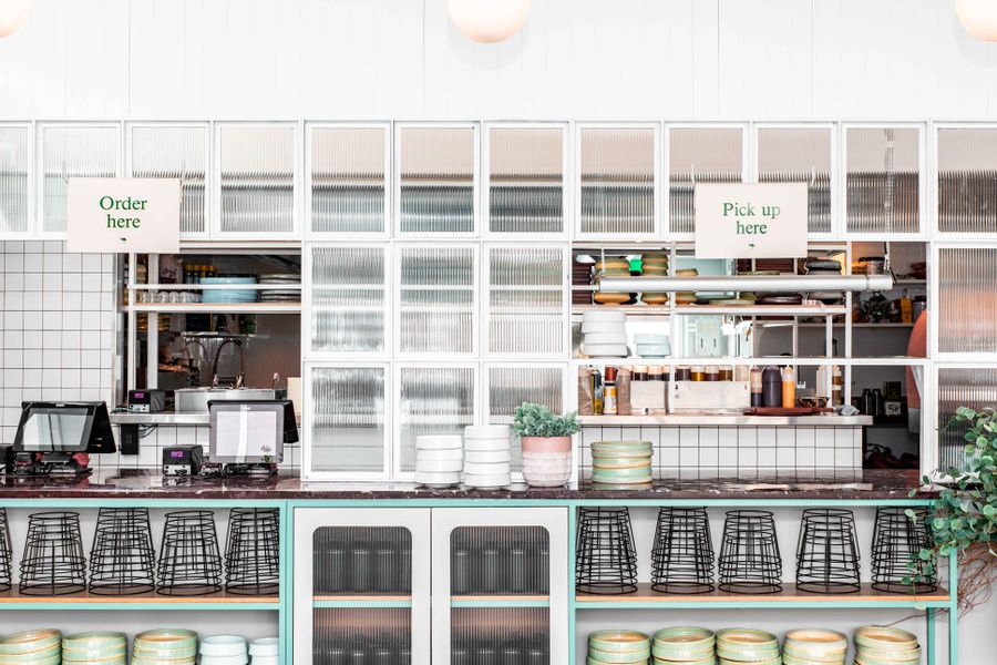 Contemporary restaurant counter with modern design and empty dinnerware.