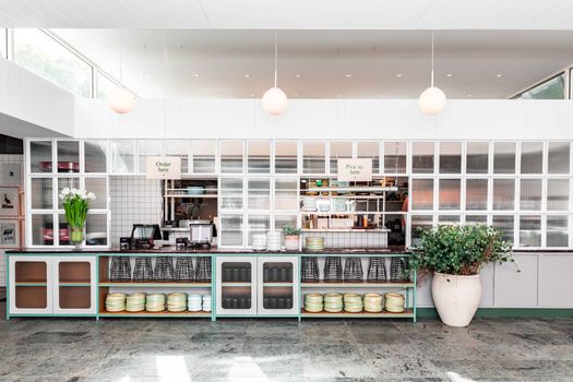 Clean and minimalist cafe counter with modern decor and organized layout.