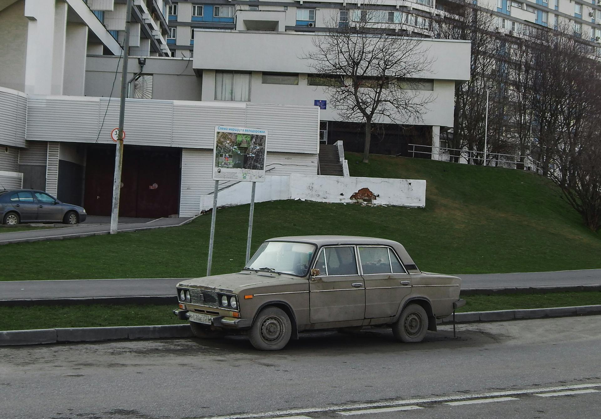 Damaged Vintage Car Parked on the Sidewalk