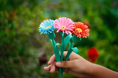A Person Holding Colorful Paper Flowers