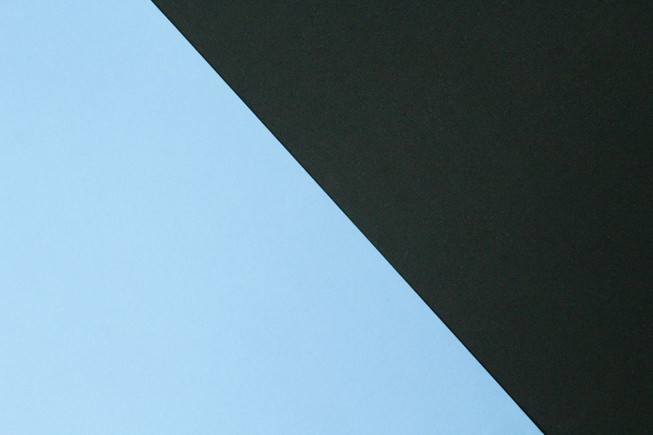 simple minimalist abstract image featuring intersecting black and blue