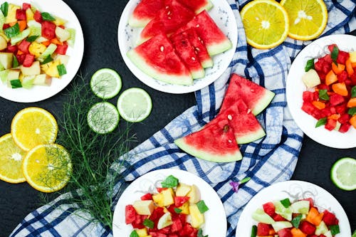 Free Plates of Healthy Fruits on a Black Surface Stock Photo