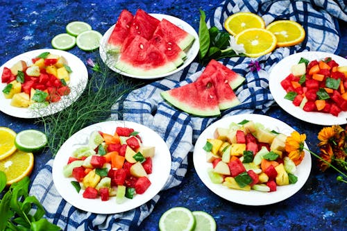 Pieces of Sliced Tropical and Citrus Fruits on Plates