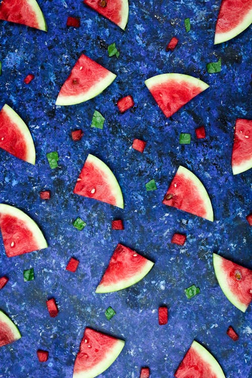 Free Slices of Watermelon on Blue Surface Stock Photo