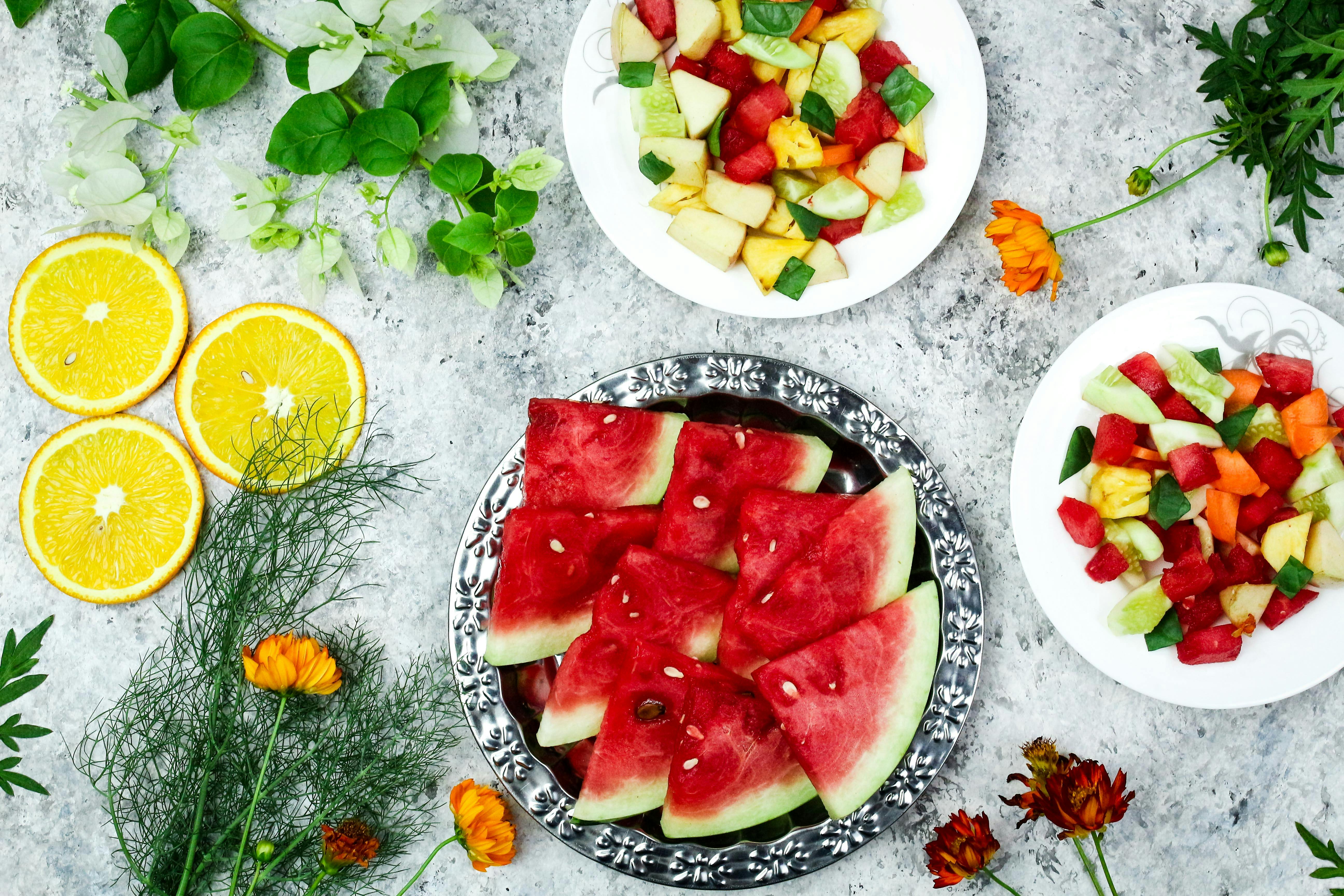 A colorful array of fresh fruit salad with watermelon and citrus, top view.