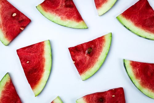Free Close-up of juicy watermelon slices arranged on a white surface. Stock Photo