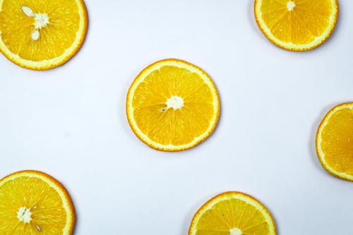 Free Sliced Orange Fruit on a White Surface Stock Photo