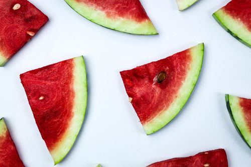 Free Close-up of sliced watermelon pieces on a white background showcasing vibrant texture and freshness. Stock Photo