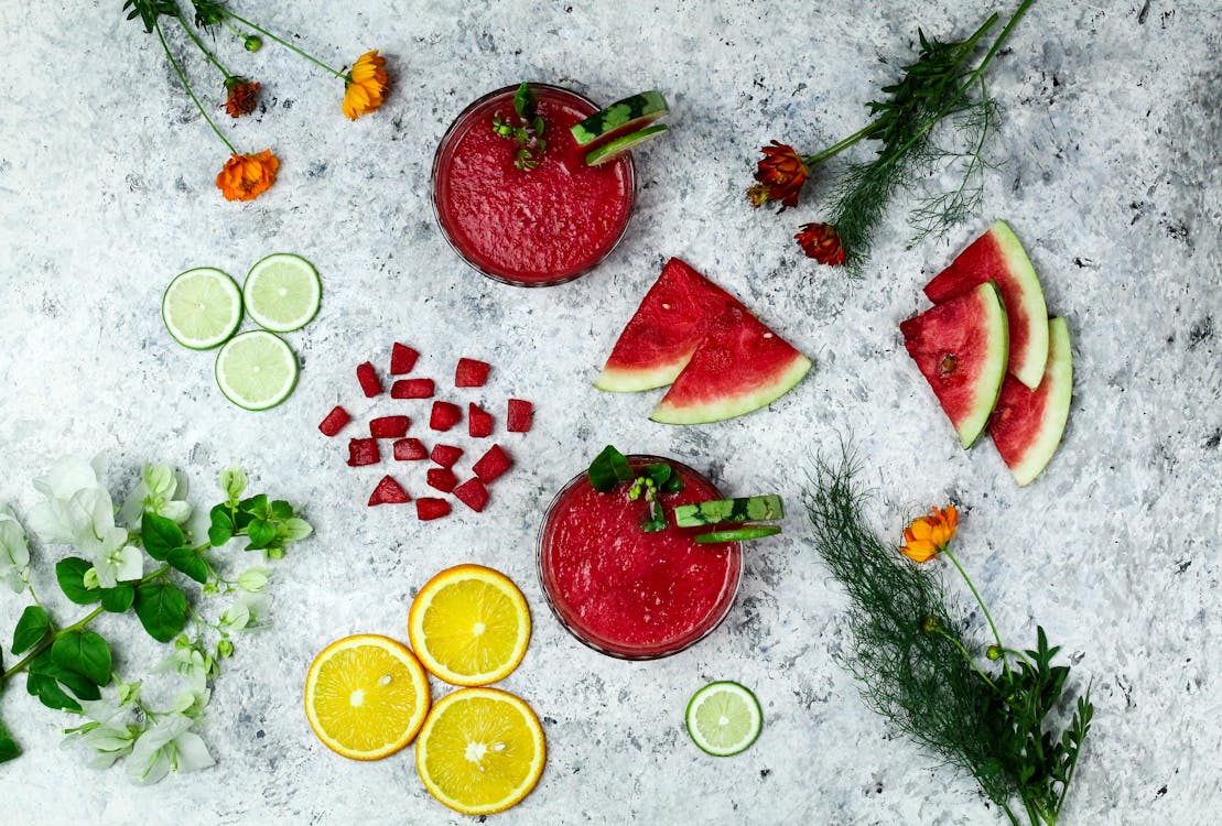 Cold Drinks Beside Slices of Fruits · Free Stock Photo