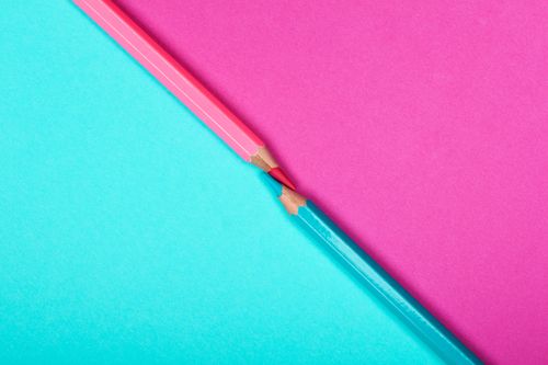 Free Close-up of intersecting pink and blue pencils on contrasting backgrounds. Perfect for creative design concepts. Stock Photo