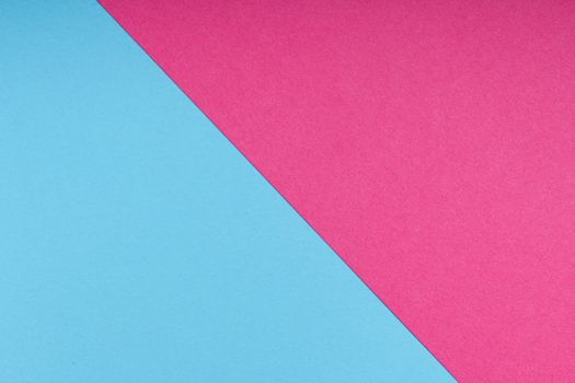 Diagonal split of blue and pink paper creating a vibrant contrast, perfect for creative designs.