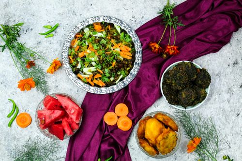 Free Vibrant flat lay of assorted fresh foods, featuring watermelon and vegetables on a fabric backdrop. Stock Photo