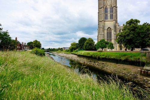 Free A scenic view of St Botolph's Church beside a river in Boston, England, United Kingdom. Stock Photo