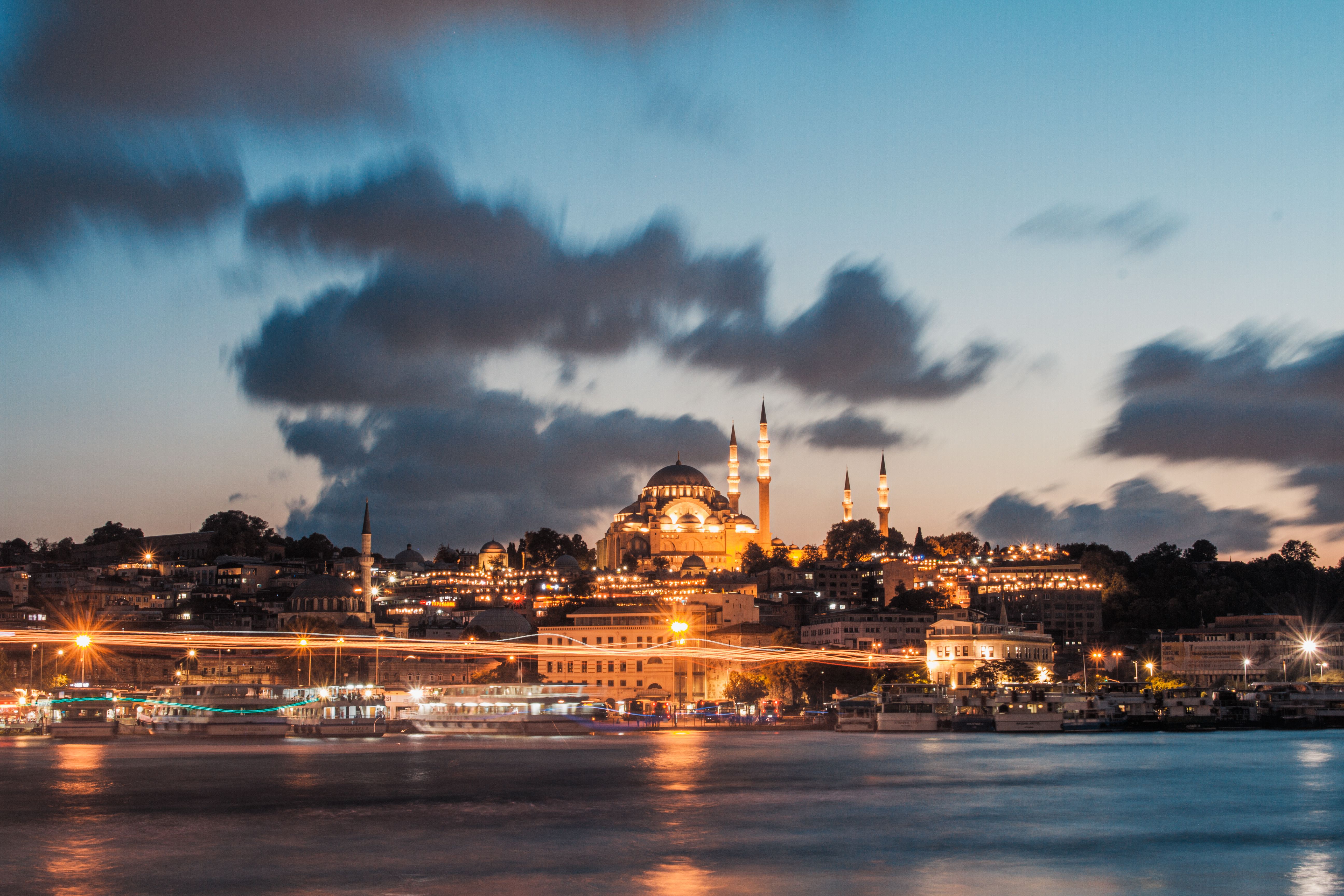 Captivating view of Suleymaniye Mosque illuminated at sunset over Istanbul's skyline.