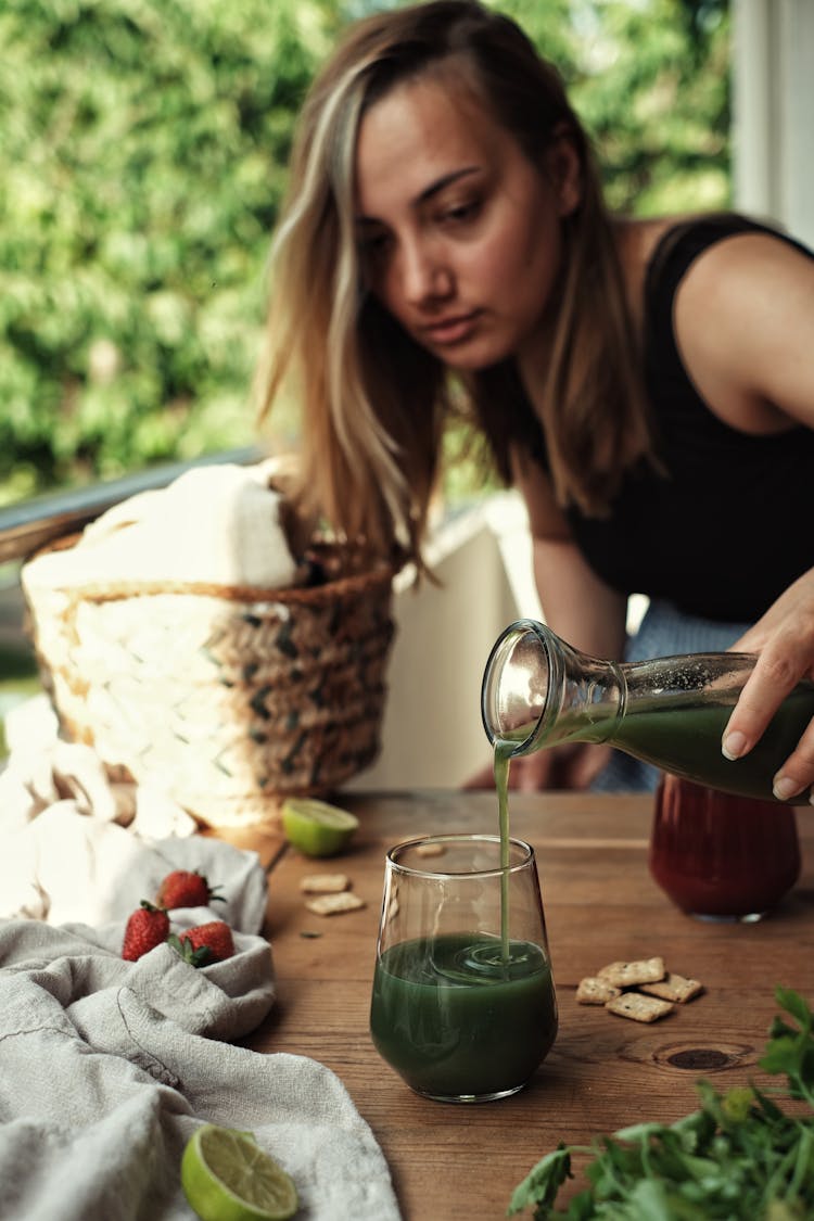 Woman Pouring Juice In A Glass