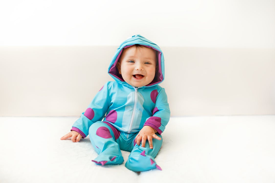 Happy Baby Wearing a Blue Costume · Free Stock Photo
