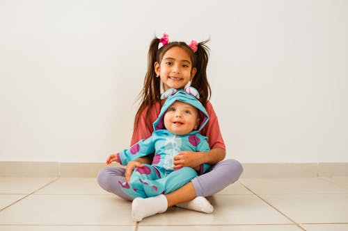 Girl Holding her Brother 