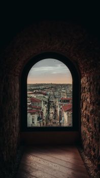 Experience a stunning view of Istanbul's vibrant cityscape framed by an ancient stone archway.