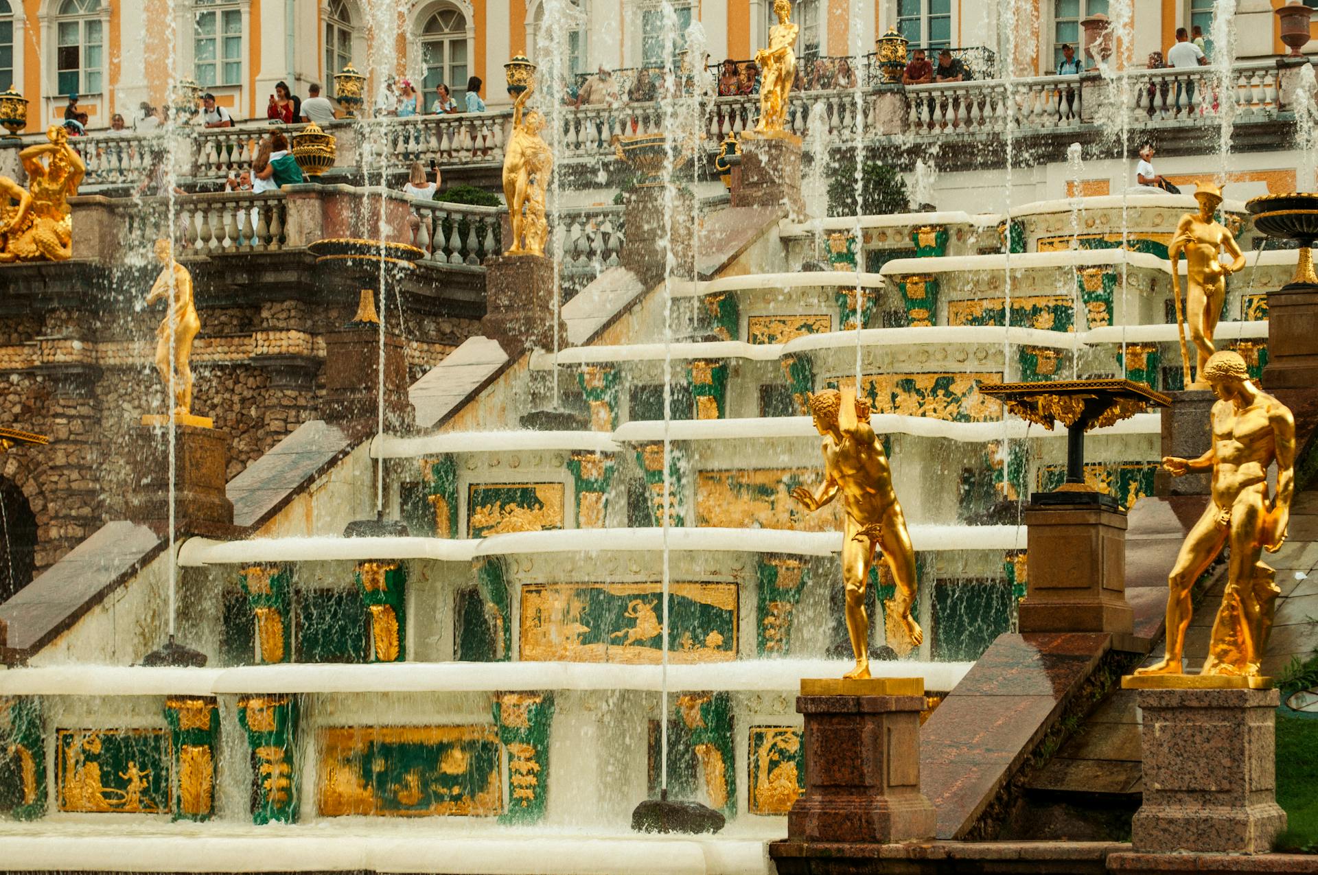 Ornate cascading fountain with golden statues at Peterhof Palace in St. Petersburg, Russia.