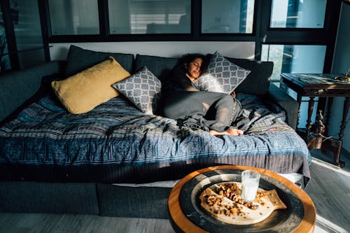 Free Woman Sleeping on a Couch Stock Photo