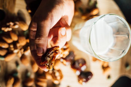 A Person Holding a Date with Walnut