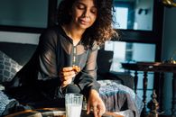 Woman in Black Long Sleeve Shirt Holding Clear Drinking Glass