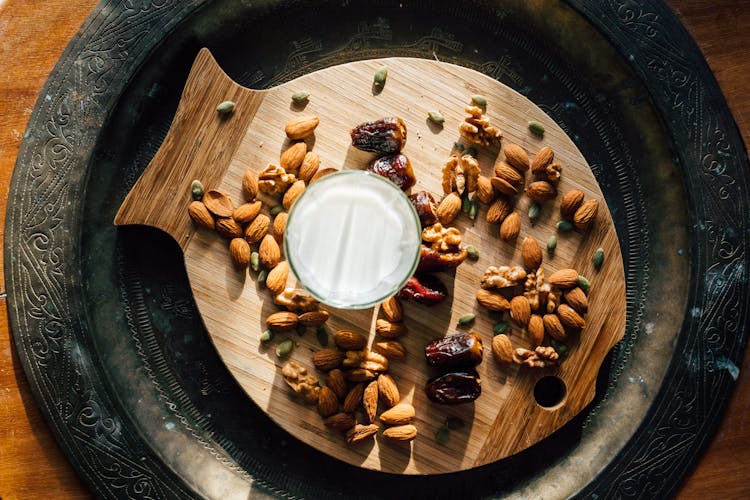 Glass Of Milk Beside Dates And Nuts