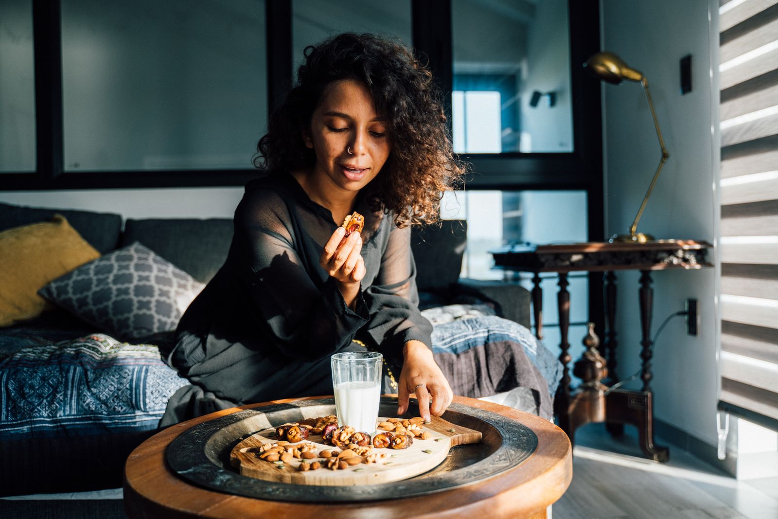 Adult enjoying a premium fruit and nut snack at home