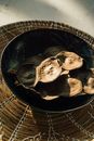 White and Brown Mushrooms on Black Round Plate