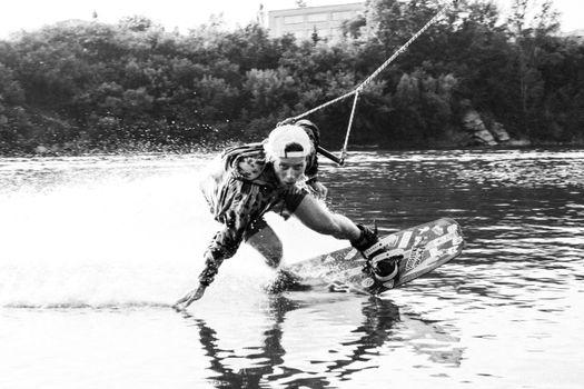 A Man Wakeboarding Clinging on Tow Rope