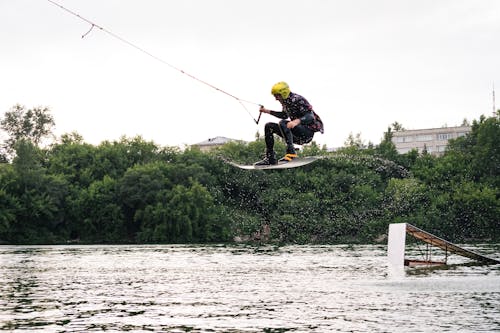 Person Jumping a Wakeboard on the Lake