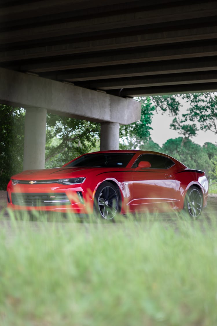 Red Car Parked Under The Bridge