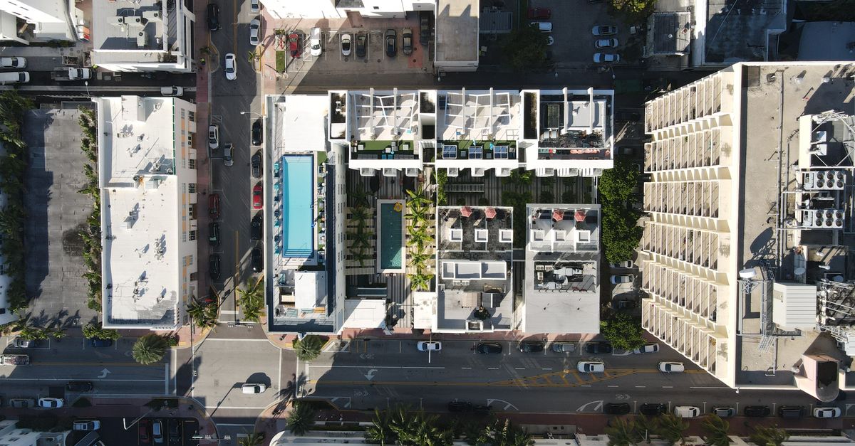 Aerial perspective of Miami's urban architecture and streets above rooftop views.