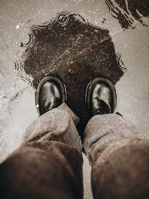 Person in Black Leather Shoes