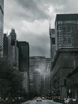 Monochrome cityscape depicting towering skyscrapers under an overcast sky, creating a dramatic urban scene.