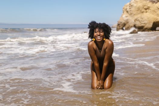 Happy Woman Kneeling in Water