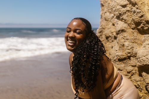 Shallow Focus Photo of Woman With Curly Hair Smiling