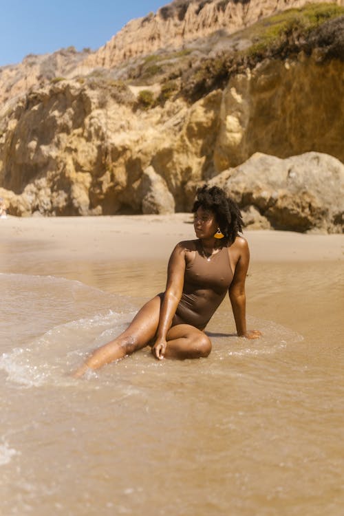Woman in Brown Bathing Suit Posing at the Beach