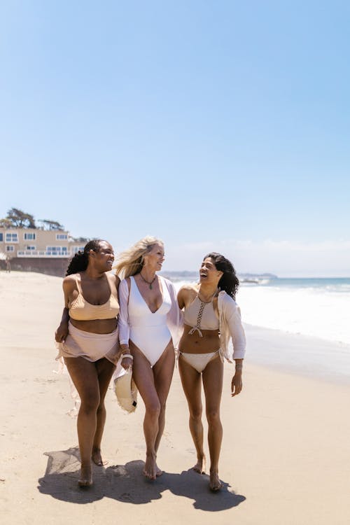 Women Wearing Bathing Suits Walking on the Beach