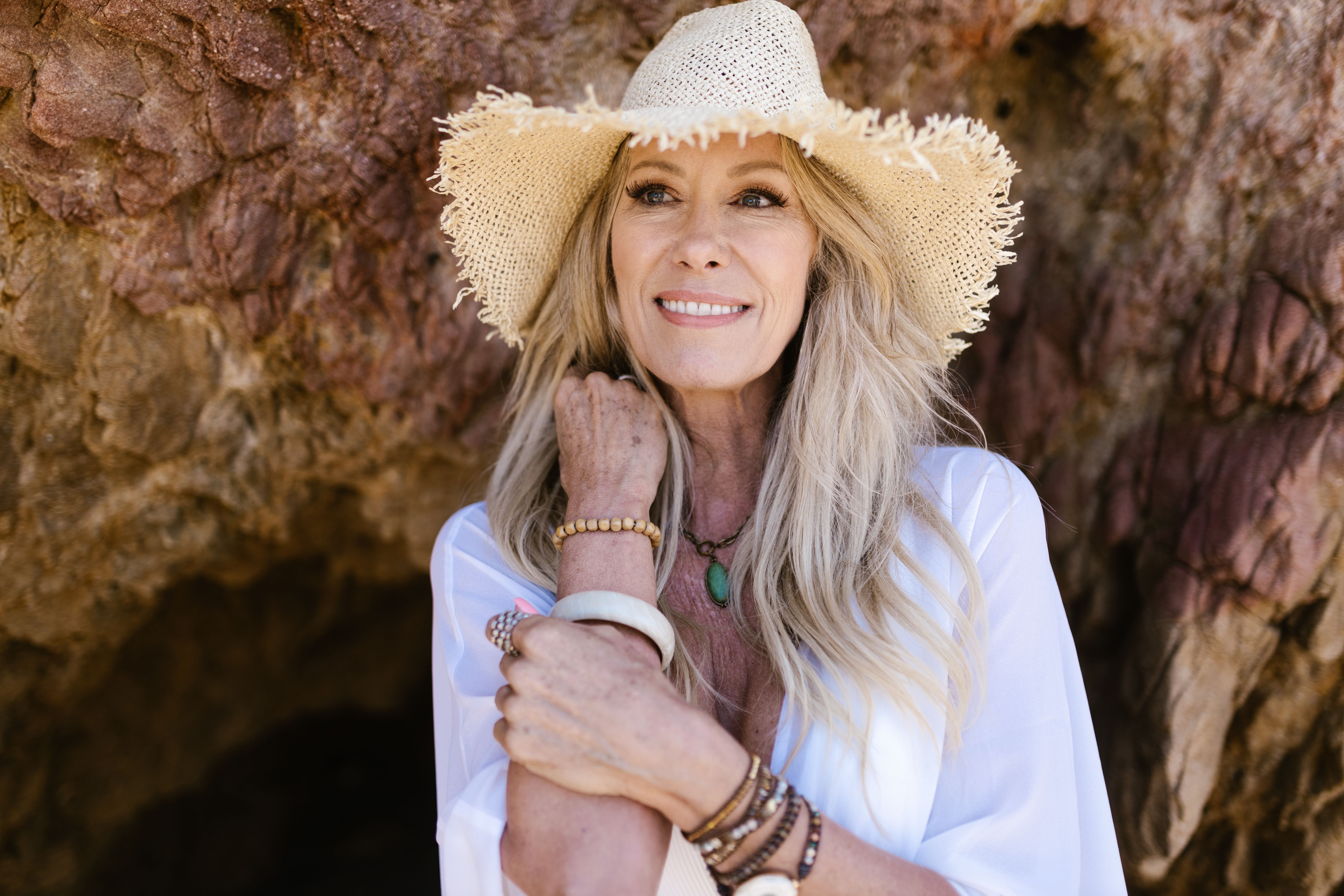 portrait of a smiling customer wearing a beaded bracelet outdoors