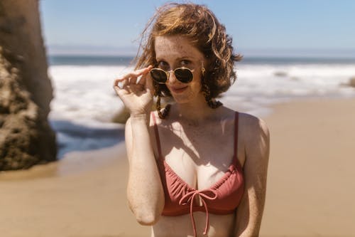 Free Woman in Bikini Holding Her Sunglasses Stock Photo