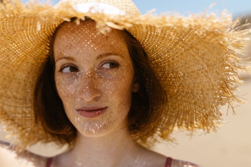 Close-Up Shot of Woman Wearing a Brown Sun Hat