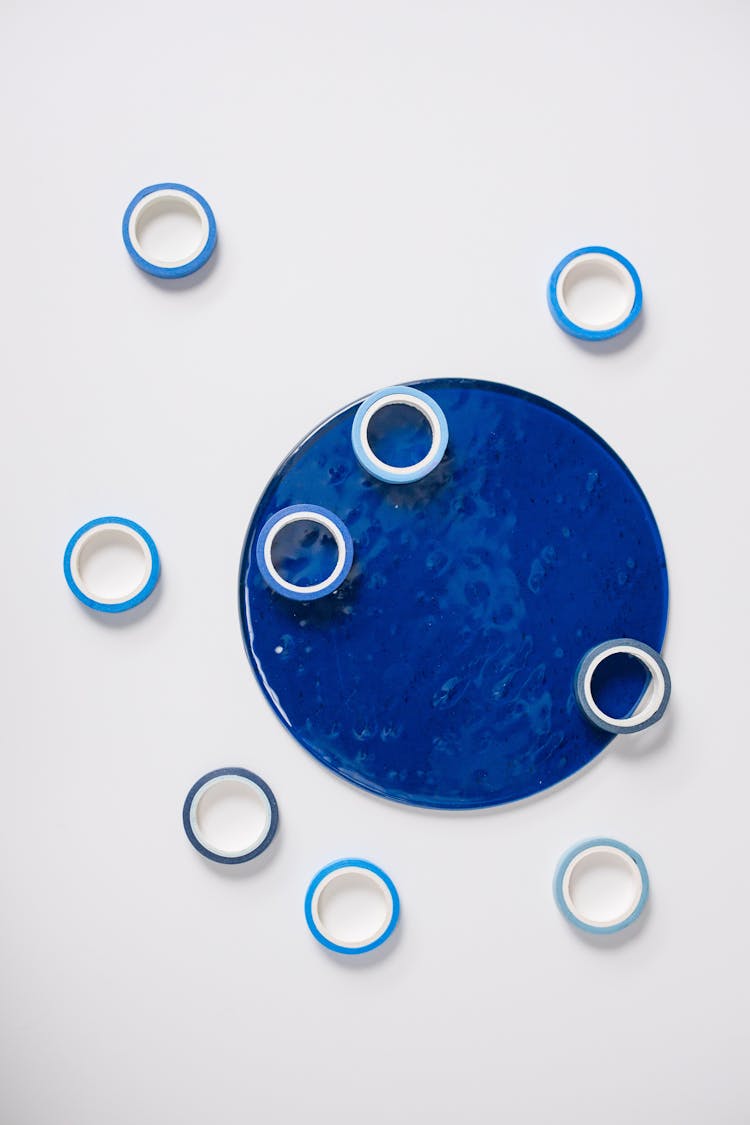 Abstract Minimalist Composition With A Blue Circle And Rings On White Background