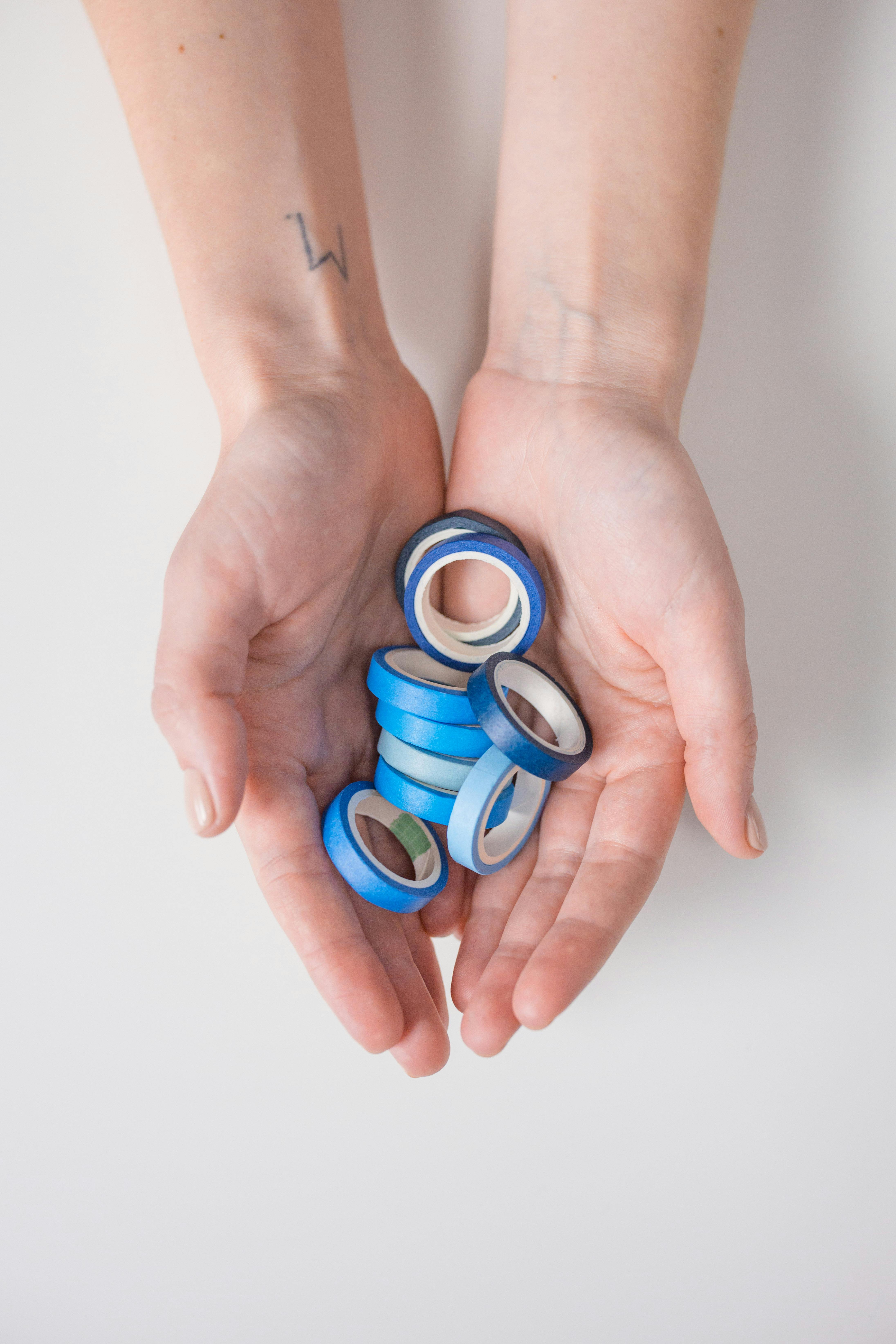 a person holding a blue tapes