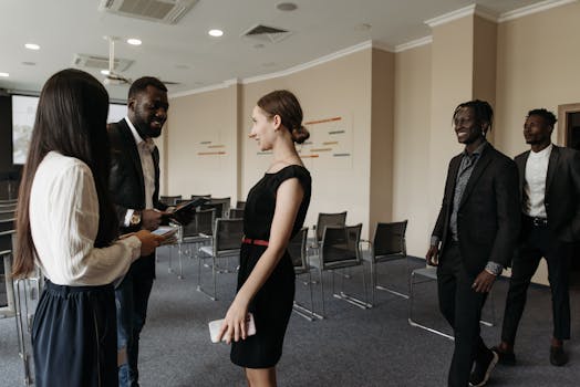 Professionals interacting in a modern conference room highlighting diversity and collaboration.