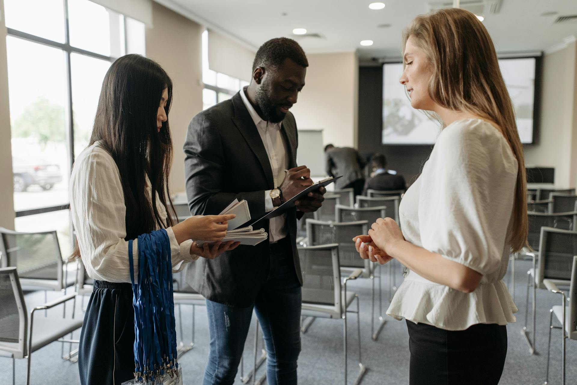 A diverse group discussing business strategies in a modern conference room.