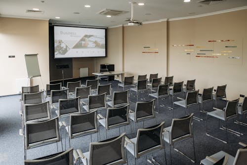 Free A Room with Seats and an Image on the Screen Projector Stock Photo