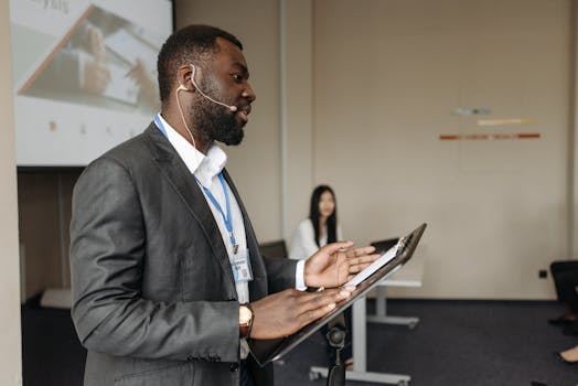 Professional speaker at a business conference presenting with confidence.