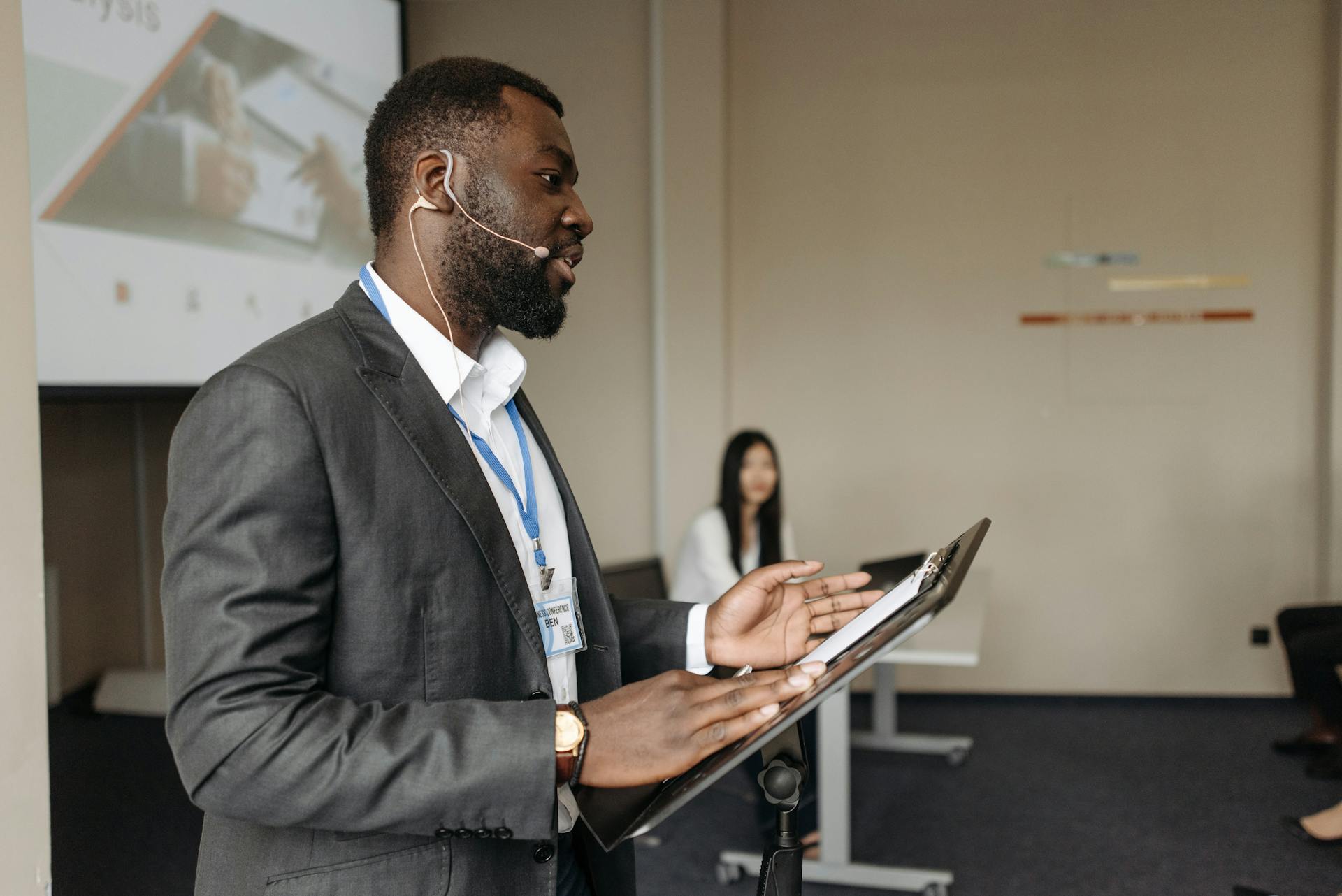 A Bearded Man Talking Inside the Conference Room