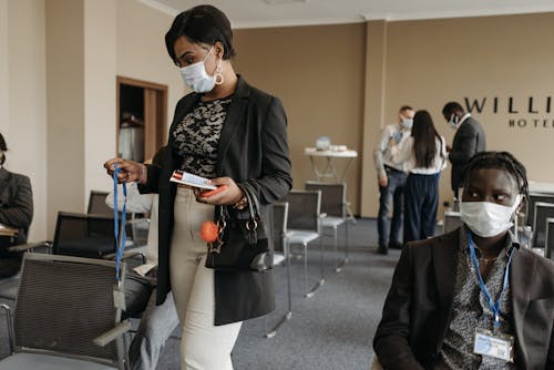 A Man and Woman Wearing Face Mask Inside the Conference Room